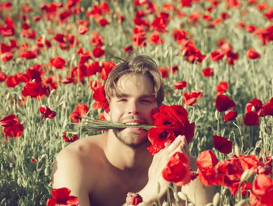 Hombre con flores en la boca.
